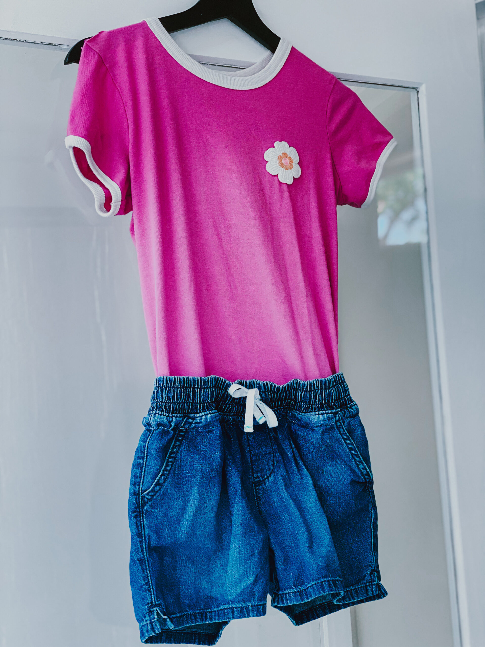 Adaptive clothing for older kids made from a purple shirt and jean shorts sewn together