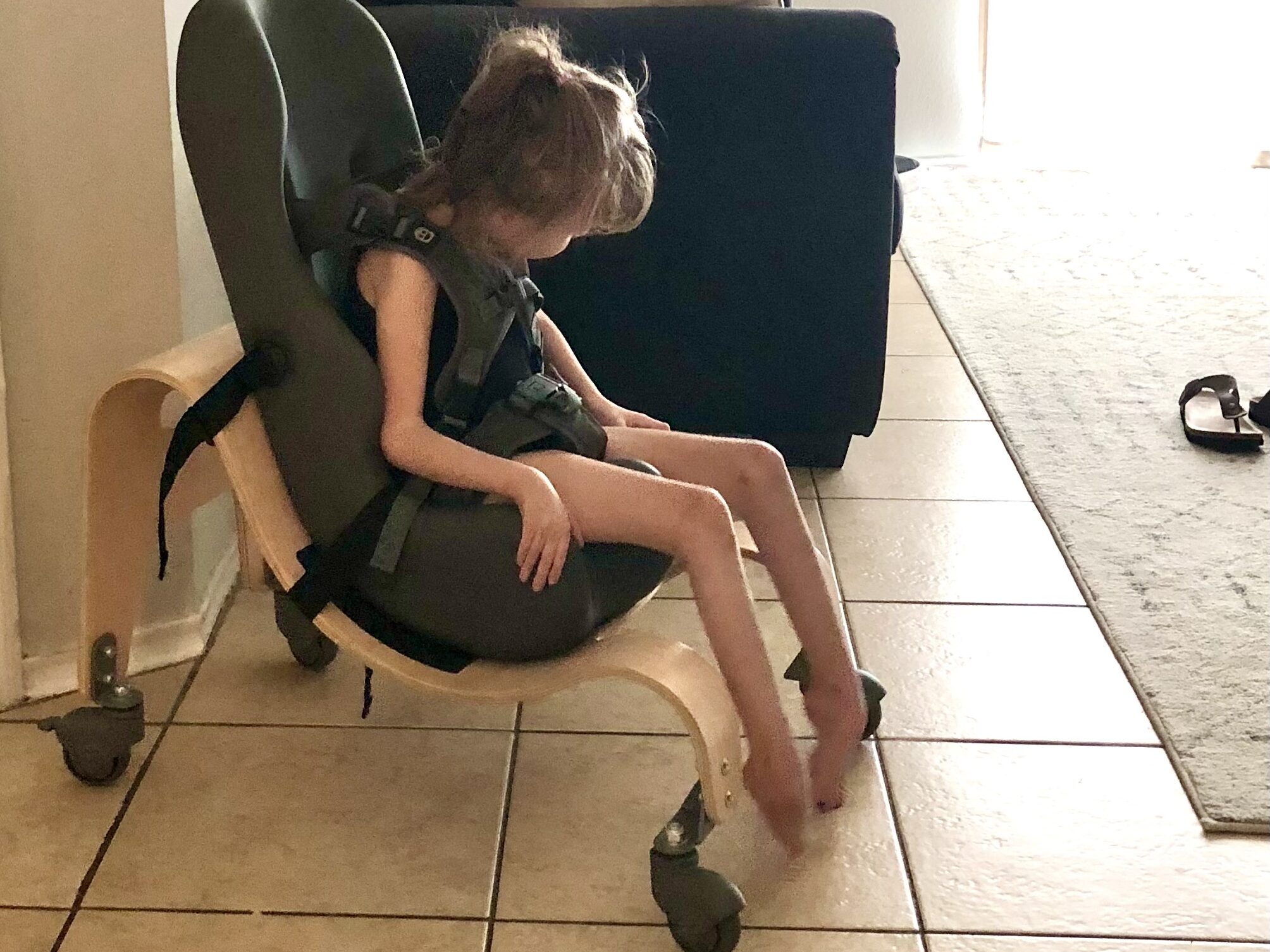Special Tomato Soft-Touch Sitter size 1 on mobile base — first adaptive seating insert received through Medicaid at age 7