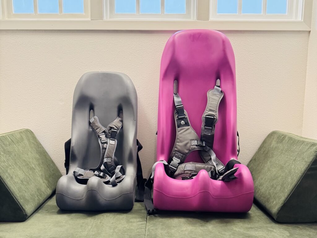 Special Tomato Sitter size 1 and size 4 side by side — size difference between adaptive seating inserts