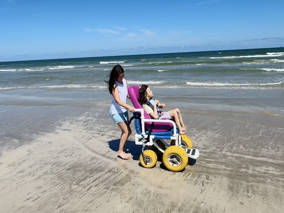 Special Tomato Sitter review — insert on beach wheelchair frame at shoreline, adaptive beach seating for medically complex child
