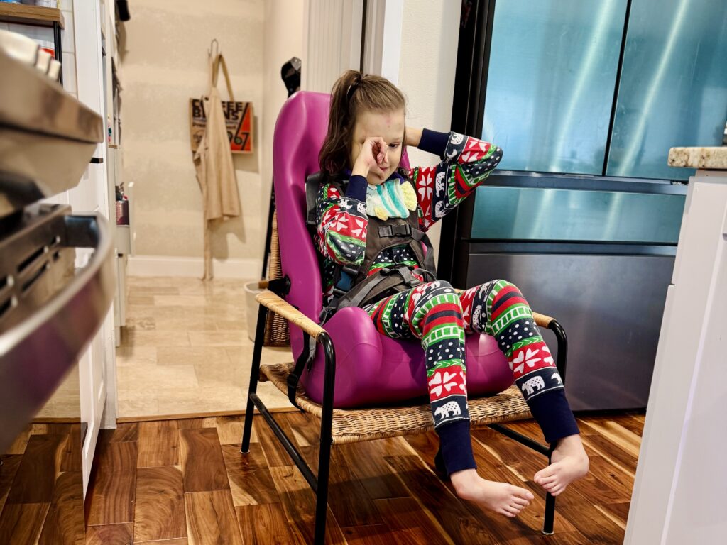Special Tomato Sitter review — size 4 purple insert on low wicker chair, home adaptive seating for medically complex child